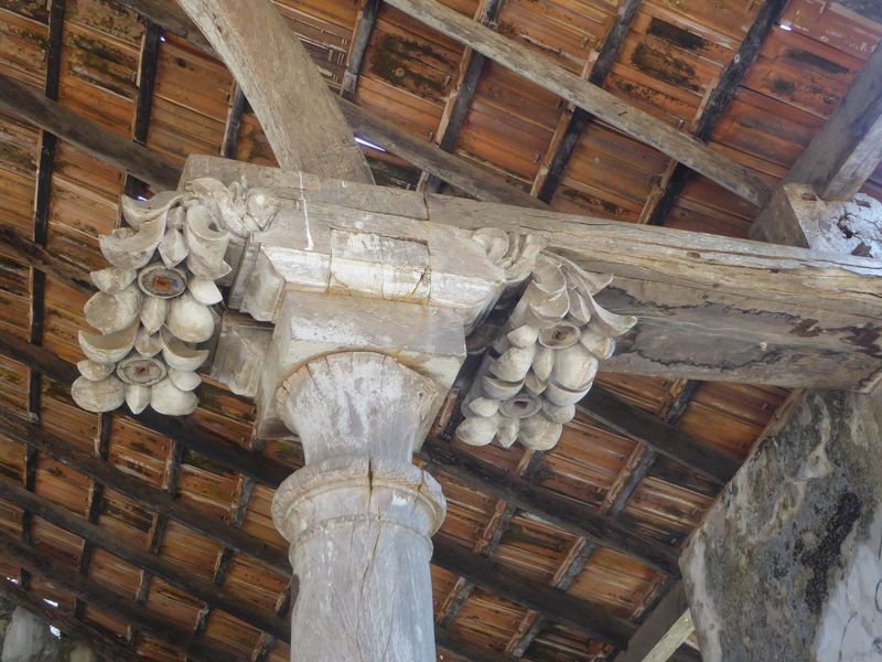 Wooden capitals suggest iconic plants. Coconuts and banana flowers?