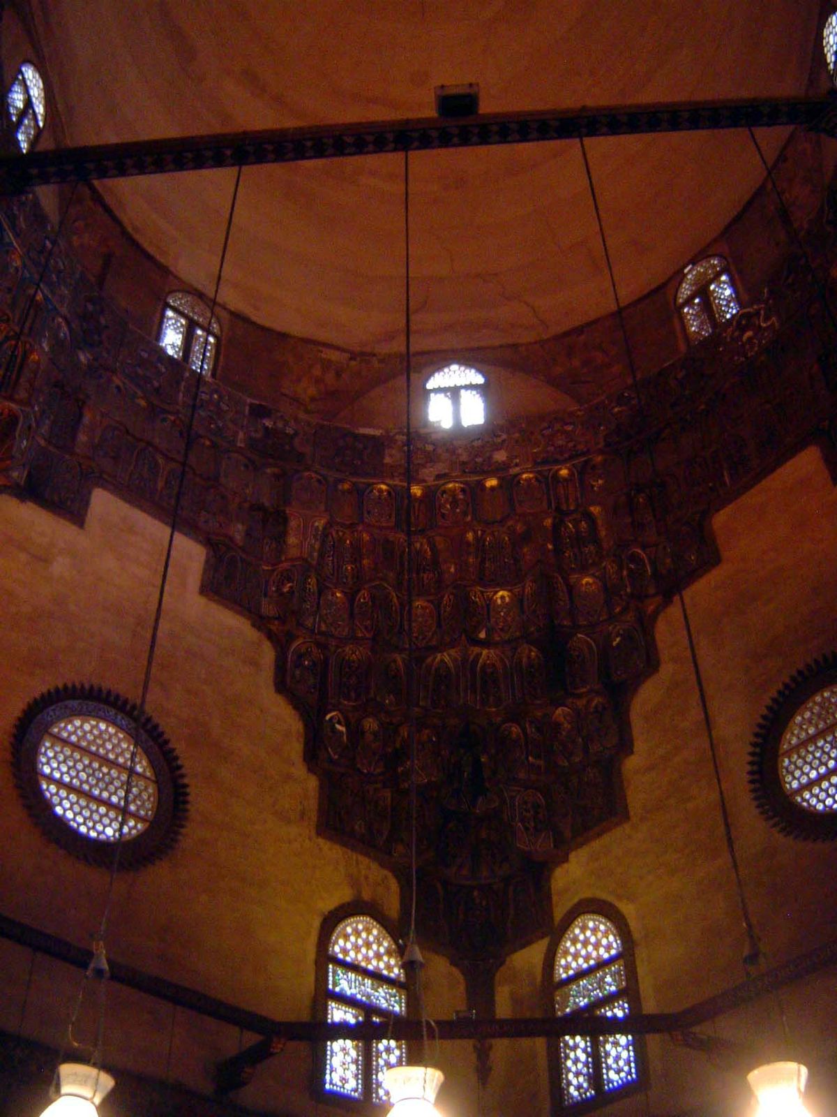 Above, the dome with wooden imuqarna\ squinches.