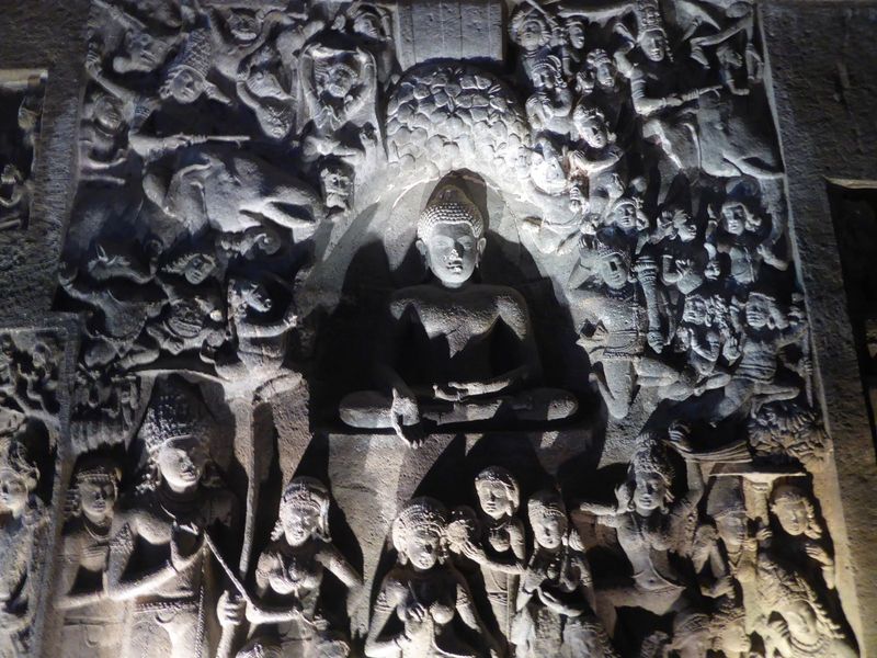 A few feet farther along the wall is this relief of the Buddha at the moment of his Enlightenment, symbolized by his touching the earth in t