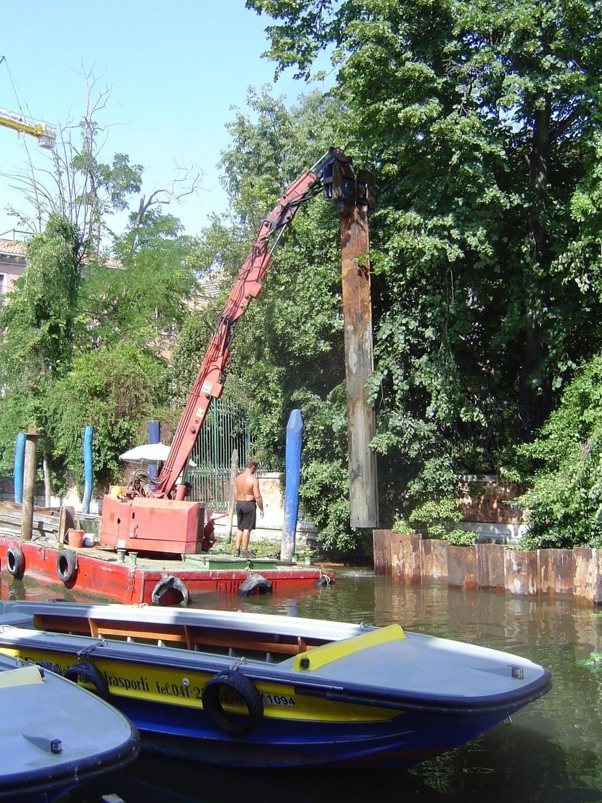 The pile is lifted free, and the barge almost reverts to a normal angle.