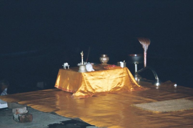 The evening setup at the Dusasvemedh Ghat. The hymn will be sung by a priest panda who sits before the microphone while four assistants act 
