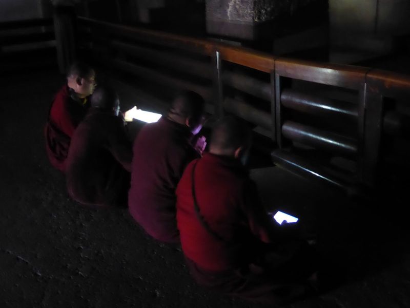 Modern monks manage to ignore the crowds and pray with a little help from iPads.