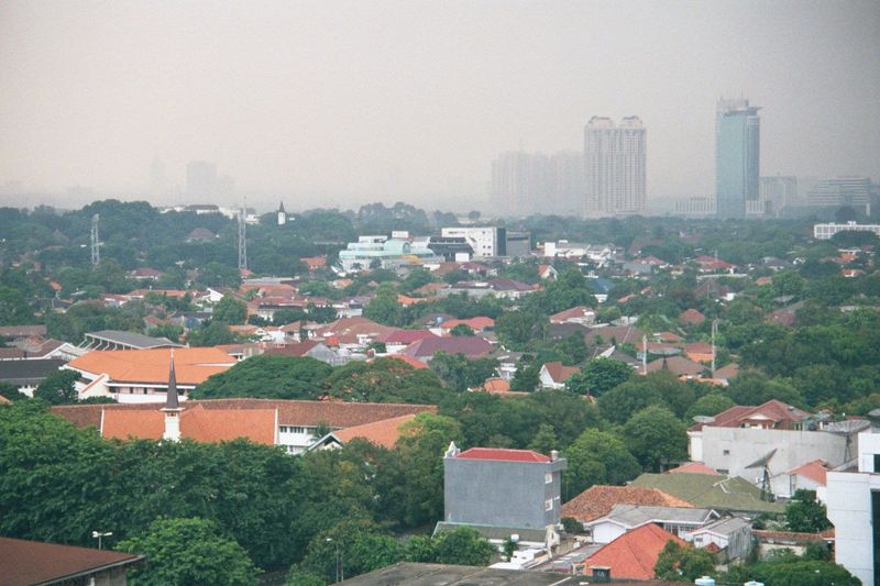 From the same roof, the view southeasterly is over the old but pricey district of Menteng, beyond which lie more towers of the new Jakarta.