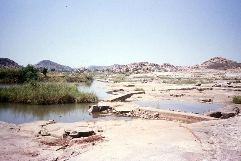 Here's a way to skip the well altogether: a crude dam blocks a river to divert its flow into a ditch. This is the headwork of one of the Vij