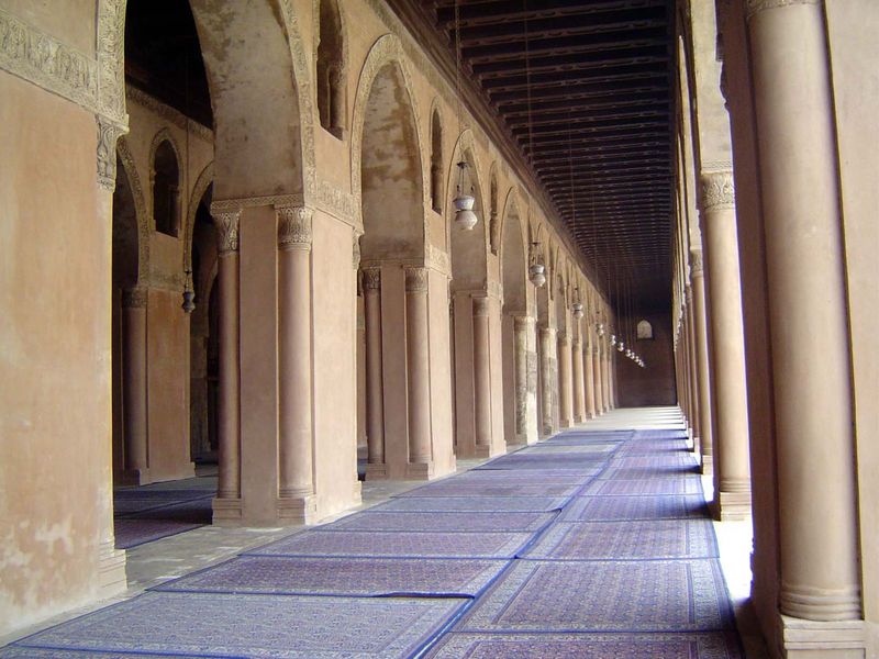 Arcades of brick piers run along the qibla side.