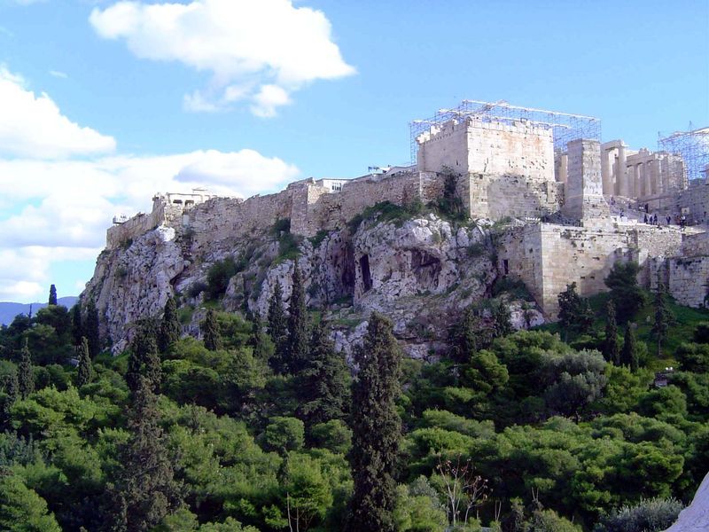 The Erechtheion, at the upper left, peeps over the northern edge. The great gate of the propylaia is on the right, or west.