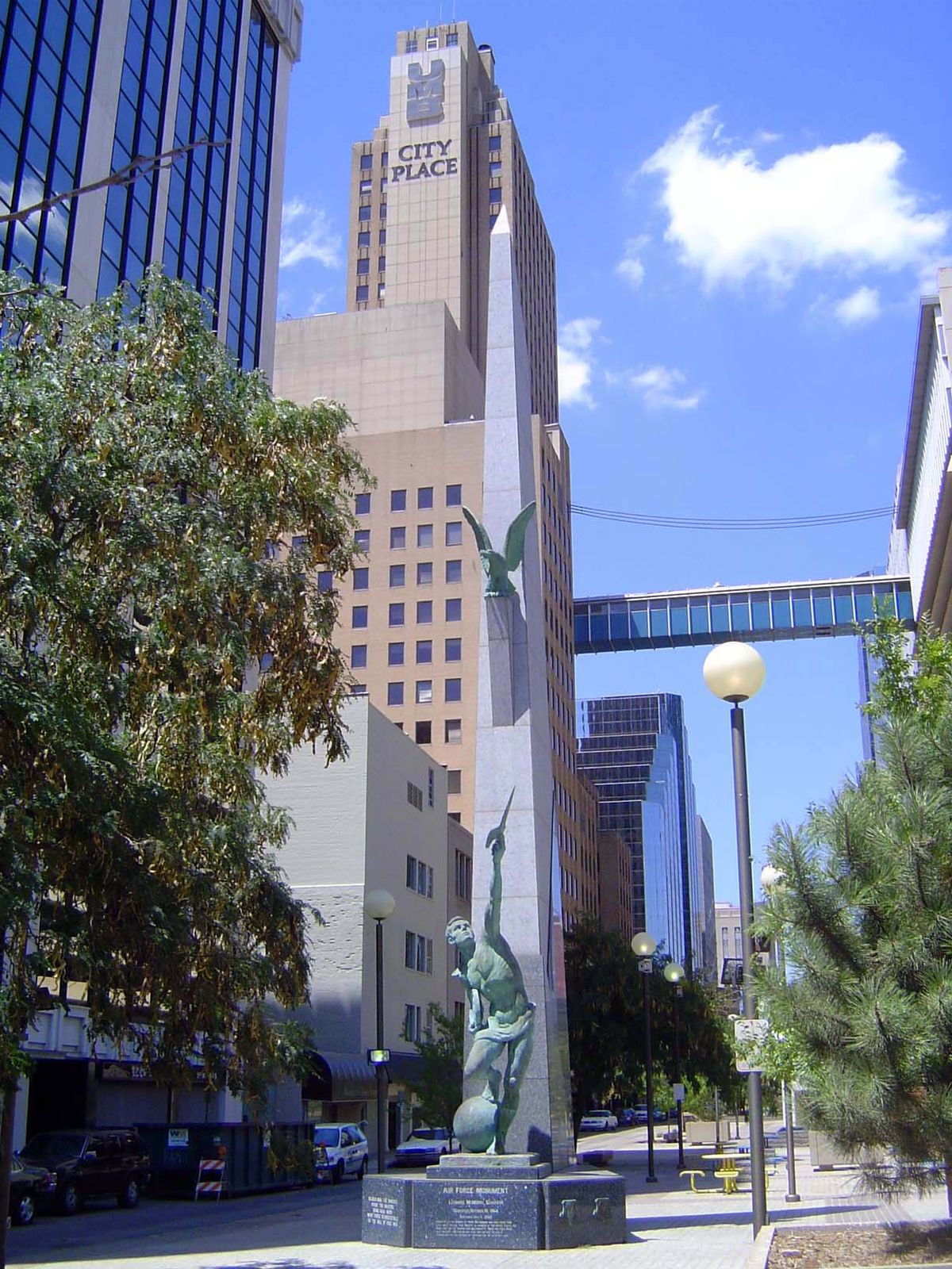 A view of one of the city's pedestrian bridges and of a monument to the U.S. Air Force, whose Tinker Field has been a key employer in Oklaho