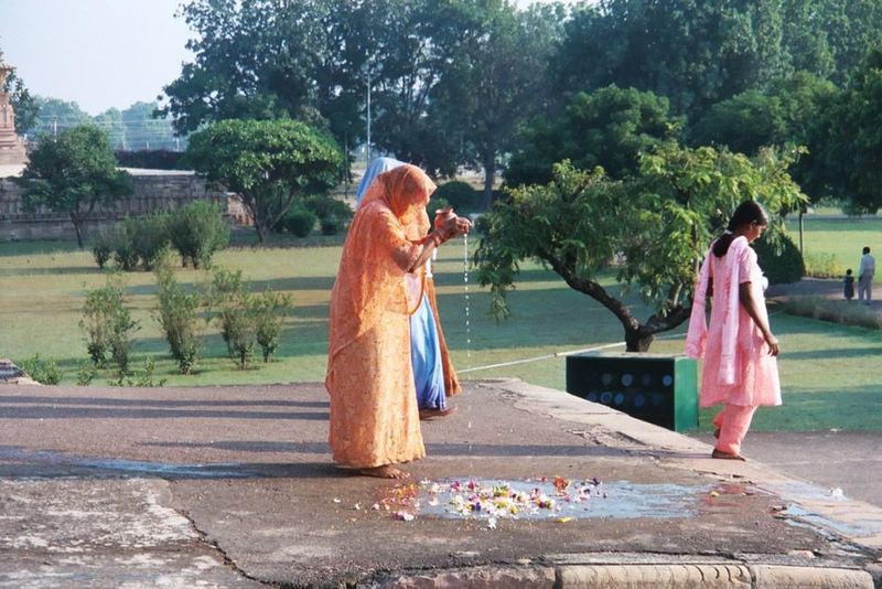 A few minutes later they depart, sprinkling water on flowers.