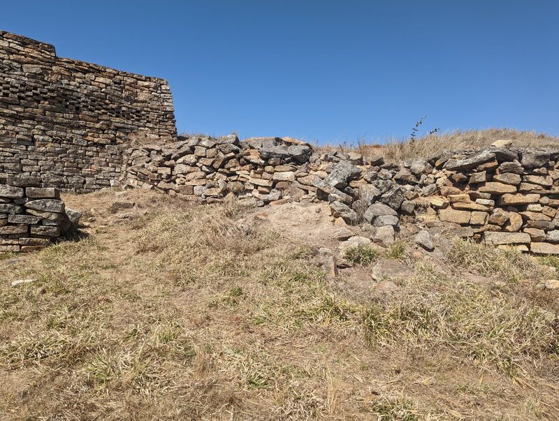 There's not much left for casual visitors, but we can climb from the chief's hut up to the outer wall, which is patterned on the inside, too