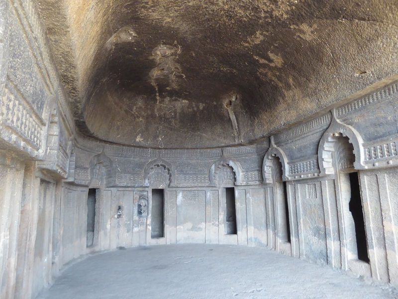 There are 11 cells, each with a bench for sleeping. "Their doors are surmounted by Chaitya-arches connected by a string-course of 'rail-patt
