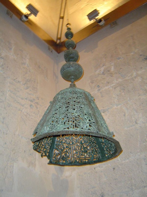 Also from the museum: a bronze lamp from the Alhambra's vanished mosque. The conical piece bears several inscriptions, including the formula