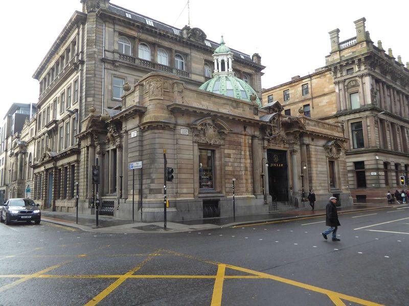 Here, on Ingram Street and about a block from George Square, is a menswear shop housed in an exotic banking hall from 1900. The hall was des