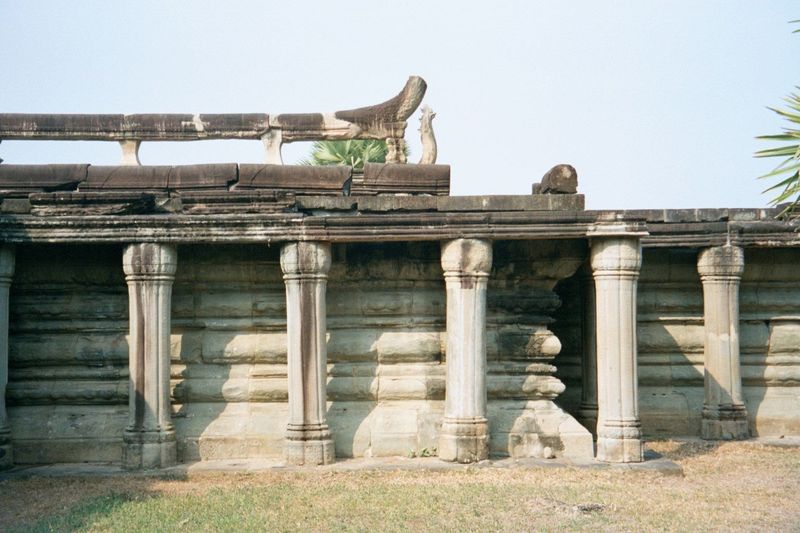 Another detail of the causeway, this time showing not only the round columns but the naga or serpent balustrade, with its vertically flaring