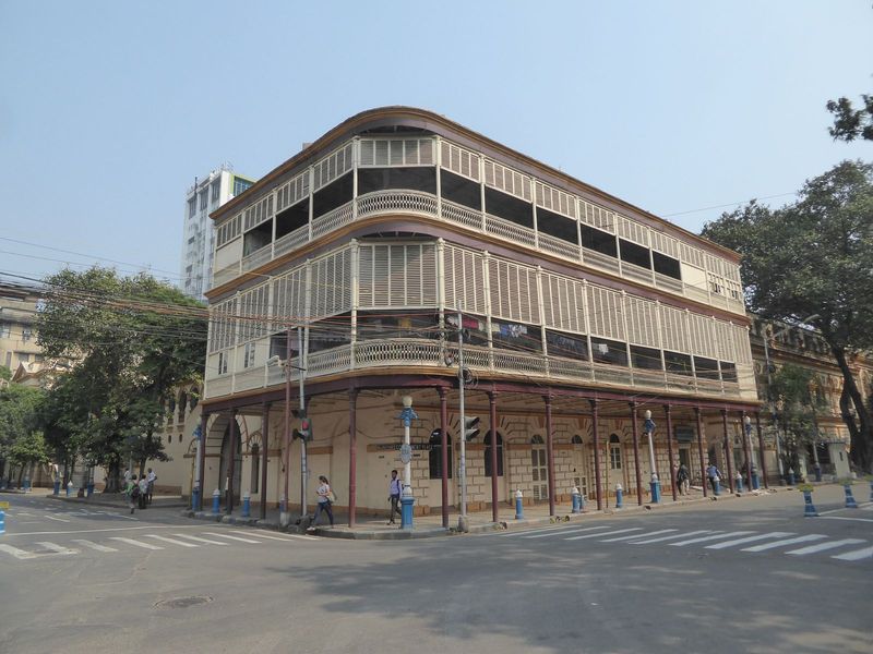 A matching building on the opposite of the street is obscured by screens but houses the Mahila Seva Samity, created in 1947 to provide relie