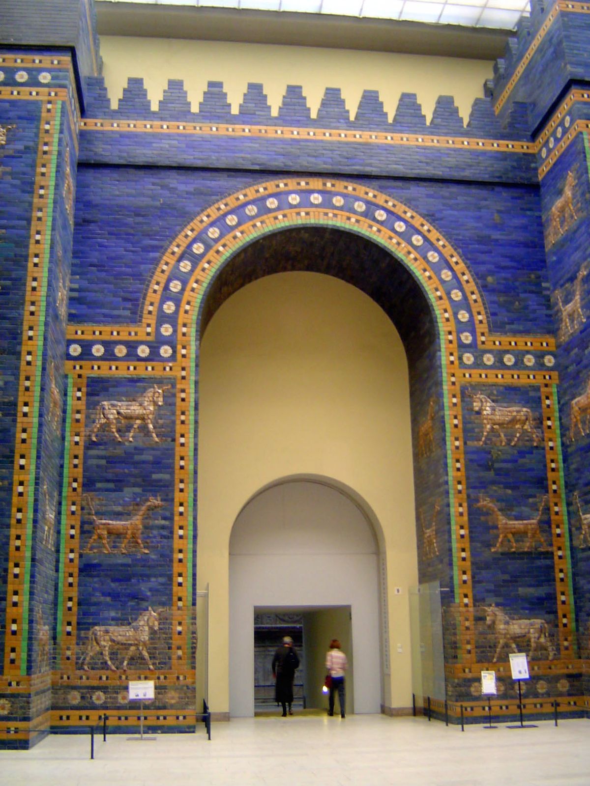 The gate is reminiscent of the gates of ancient Mesopotamia, exemplified by Babylon's Ishtar Gate, shown here as reconstructed in Berlin's P