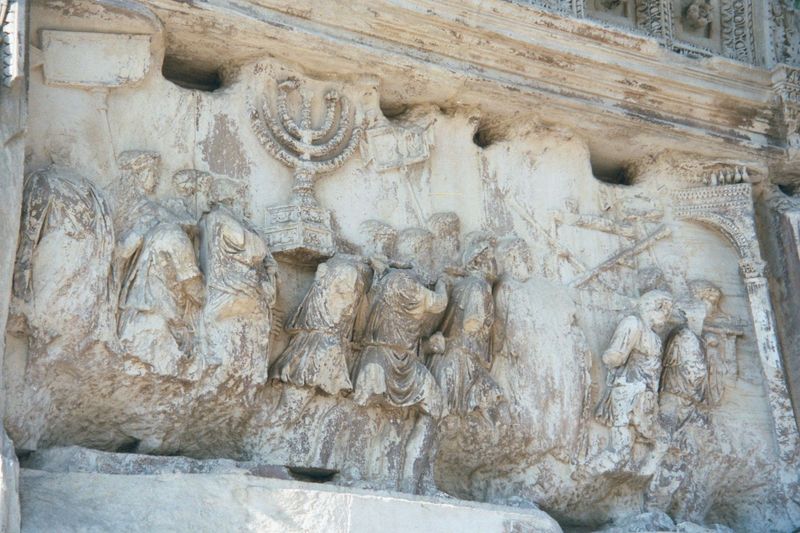 One worn relief on the Arch shows a menorah being carried away from Jerusalem.