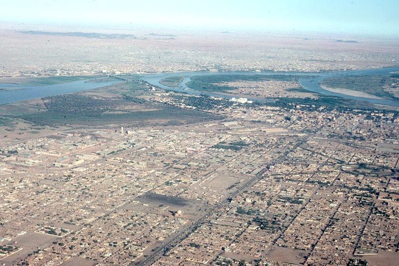Omdurman lies in the distance and can be reached by the cantilever bridge visible crossing the White Nile just above the confluence with the