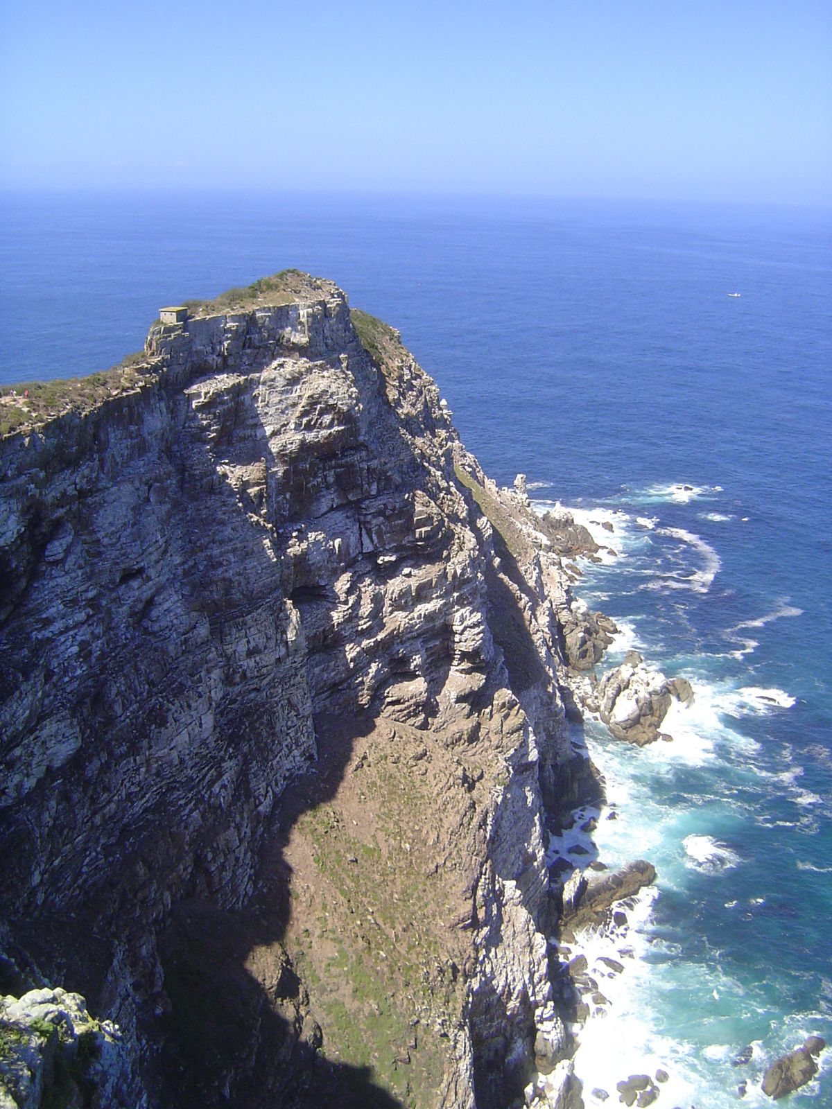 Cape or Dias Point is about a mile to the east; there's a light house down there; a bit of its white roof is visible.