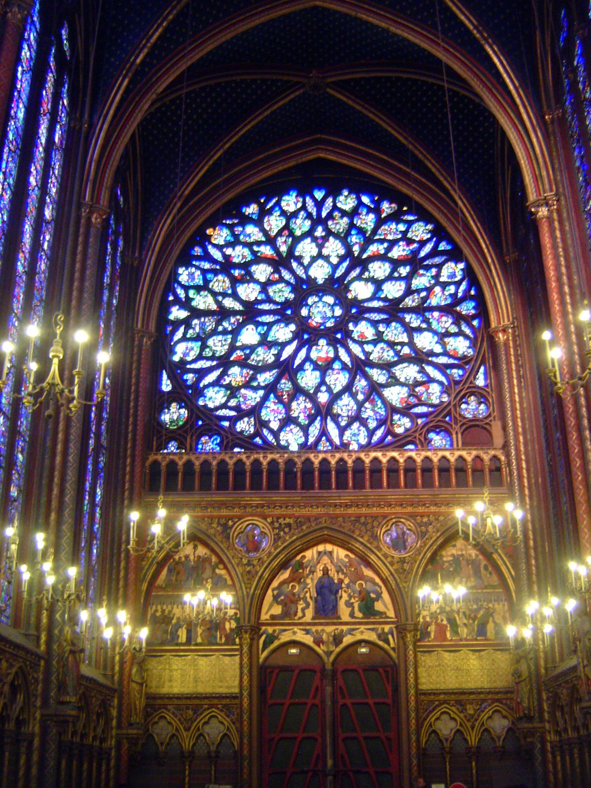 The west end contains a 9-meter-diameter rose window rebuilt about 1490 by Charles VIII. The rose seems even bigger than it is because the l