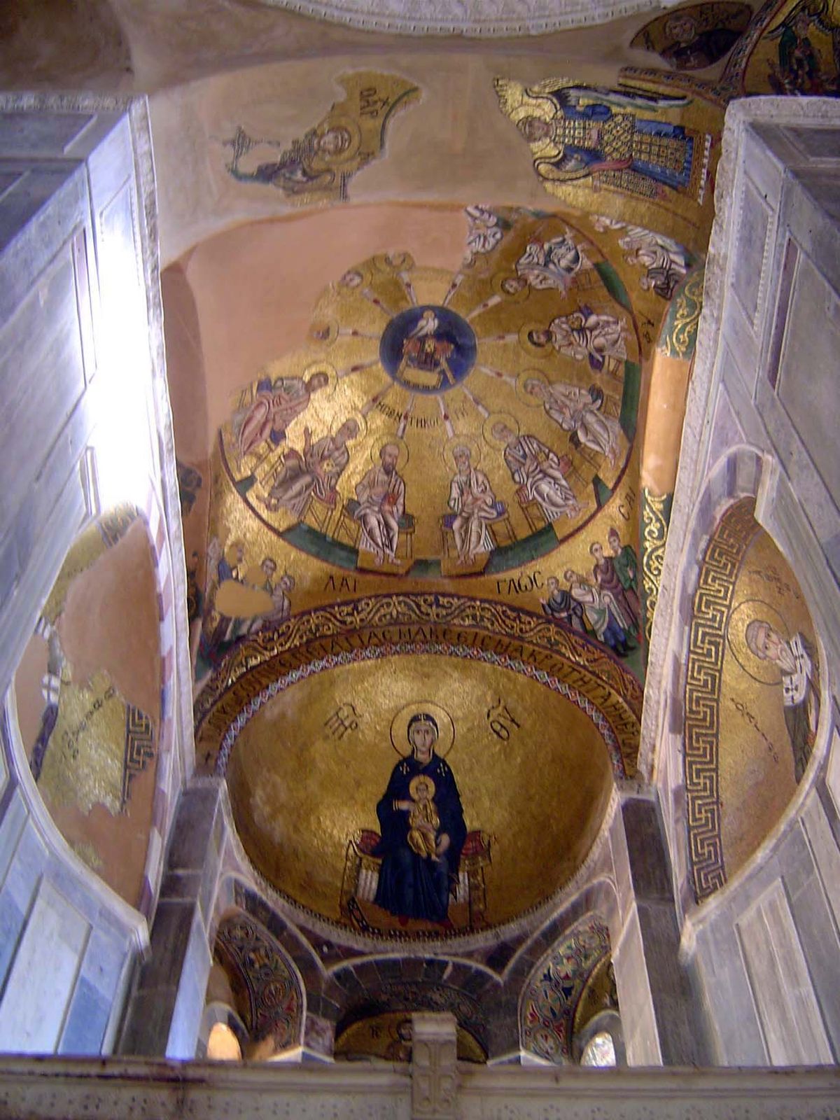 Above the sanctuary, the virgin is enthroned; still higher, a circle of the pentecost.