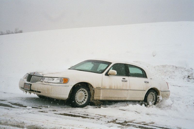 Outsiders do screw up—in this case park on a hill of glare ice, walk away, then watch as their tires lose their grip and the car slides ever