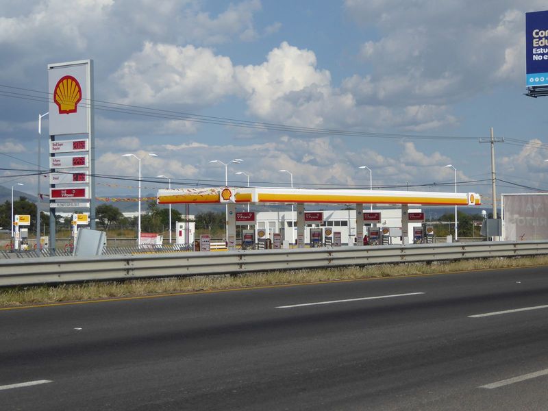 Stores like these imply shoppers with cars, which at least partly explains highways like this and gas stations to match.

Anyone who grew up