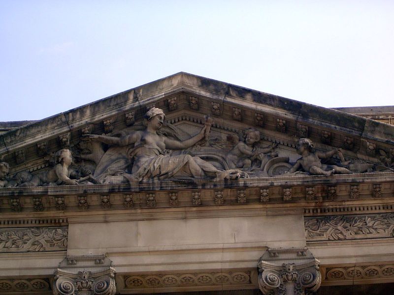 The pediment sculpture shows a cherub putting the pedal to the metal. Thank Ferdinand Faivre, who also worked on the Cairo Museum and the pa