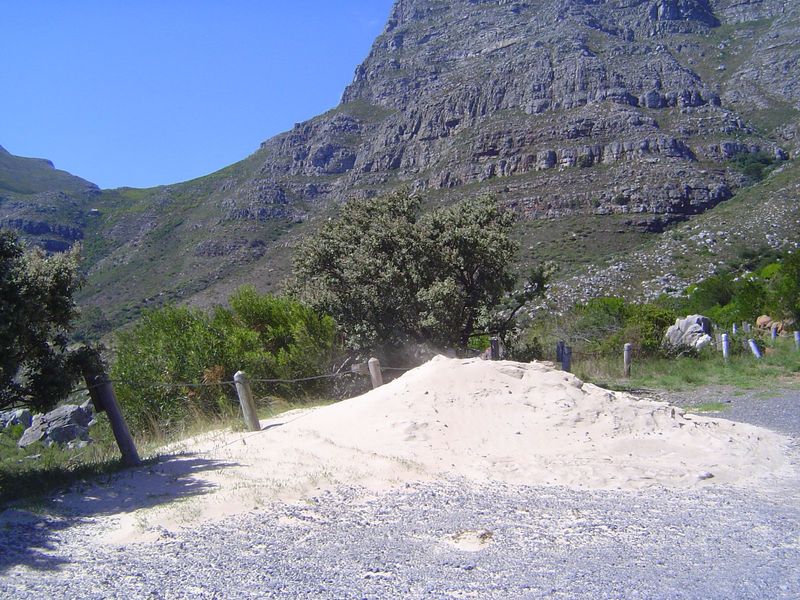 Think it's a nice day? Look at the top of the sand pile. The wind was blowing hard enough not only to set the sand moving but to stop the ca