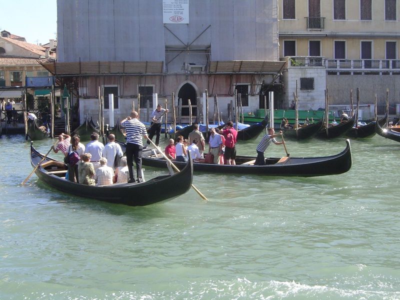 Ferries still cross the Grand Canal. Most passengers stand, and habitual strap-hangers have to watch their balance.