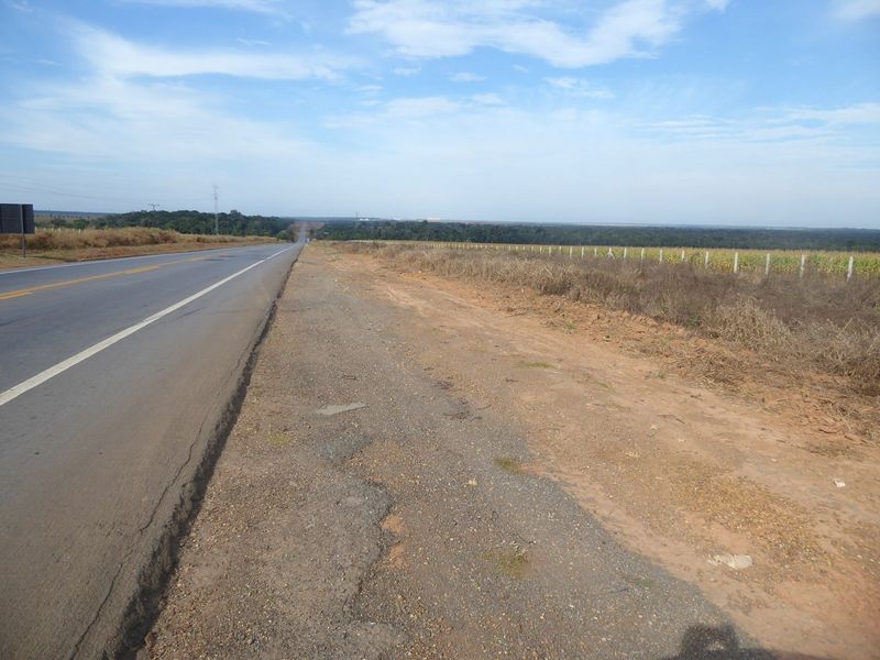 You get the contrast between primeval forest and modern agriculture. We're heading south now. Notice the sprinkling on the ground?