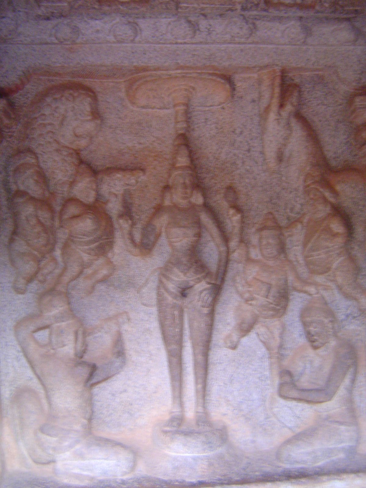 On a panel facing outwards, Durga is worshipped by a devotee so devoted to her that he is about to cut off his own head. The more sensible d