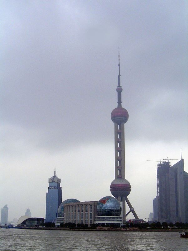 Across the river is Pudong, an immense area, roughly triangular with one side the Huangpu, another side the ocean, and the third side a line