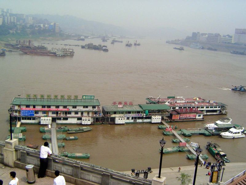 We've come down to the muddy confluence and are looking downstream, over floating docks for passenger boats. The Yangtze is on the right.