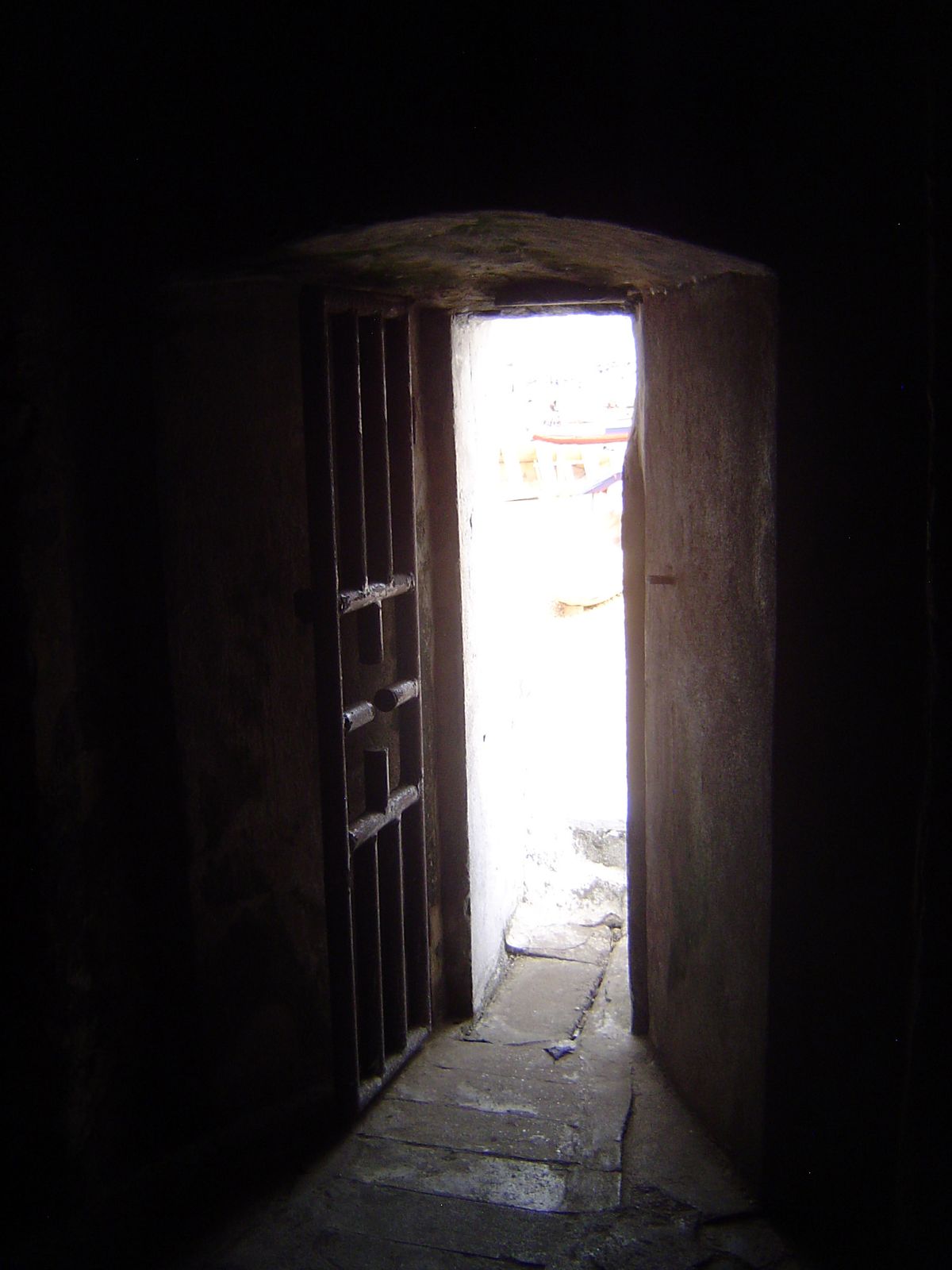 A narrow door leads from a dungeon to a water-side exit. There might as well be a sign saying "one-way."