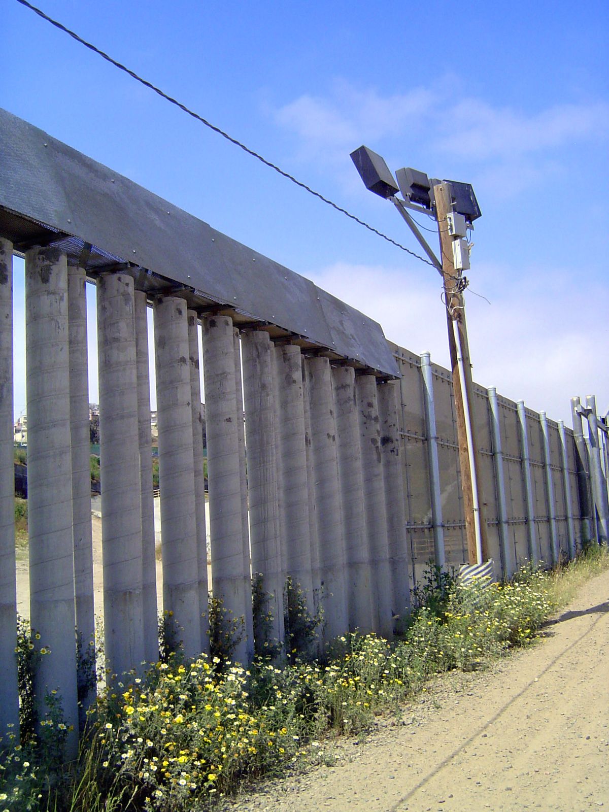 Variety is the spice of life, in this case an unusual fence of tightly spaced concrete columns capped with a sharp wedge of metal.