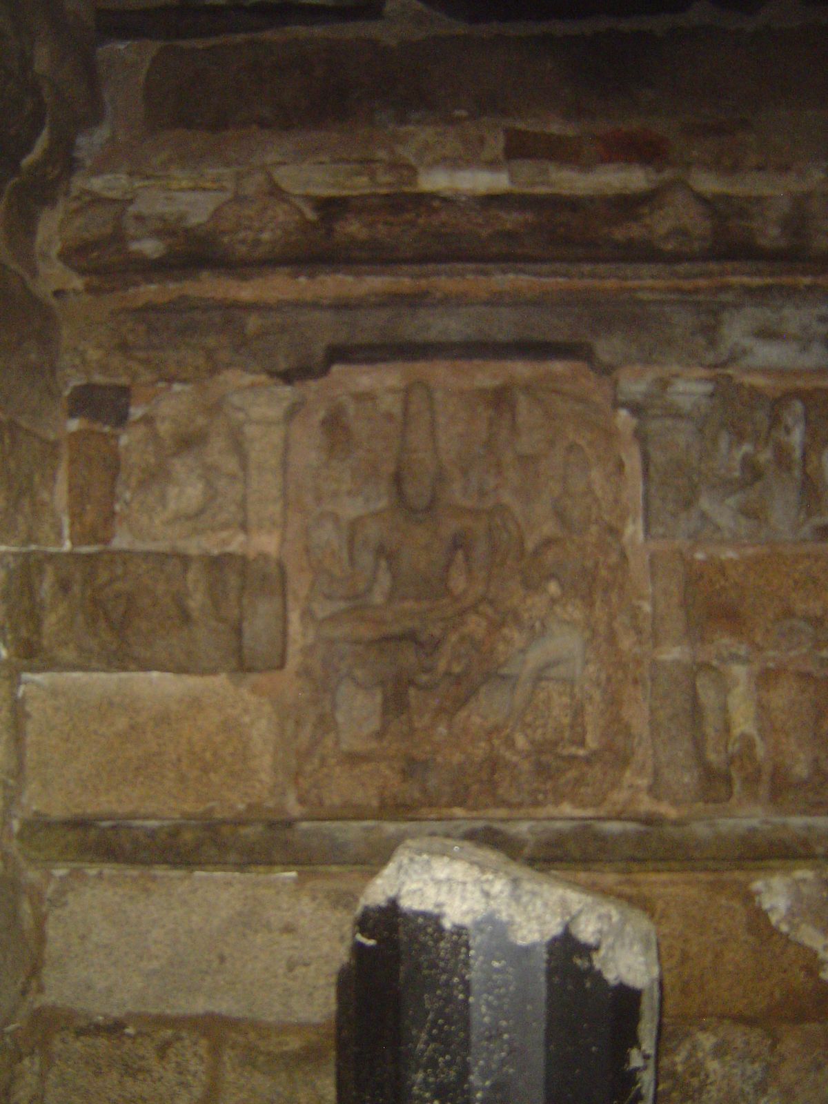 The sanctum itself contains a Somaskanda panel, in other words a family portrait of Siva, Uma, and Skanda. The broken lingam is the original