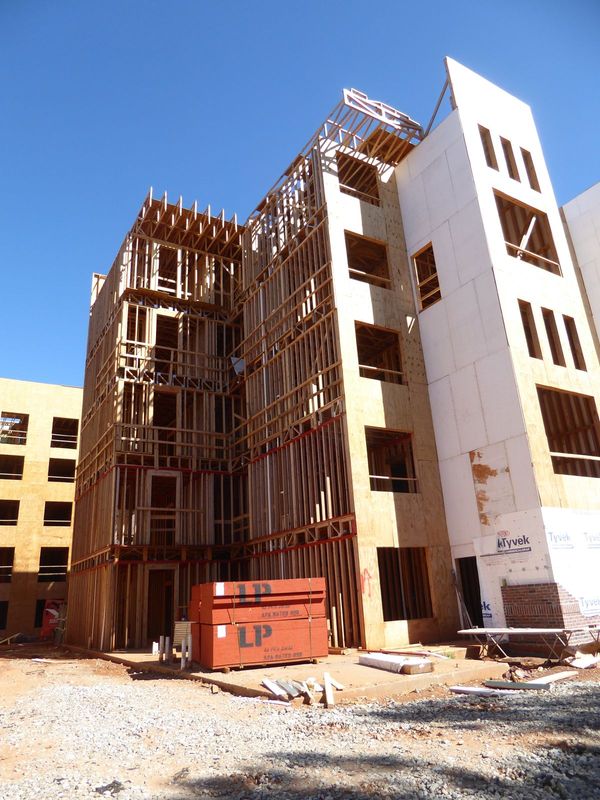 Would you guess that such a building has a wood frame? Here's your proof. Apparently, framing is at least 10-20 percent cheaper with wood th