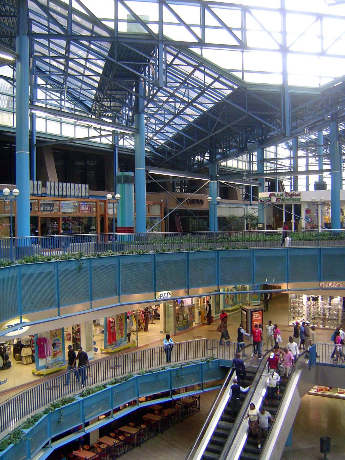 A mall between the towers survives, though the gloomy entrance to the hotel—seen on the upper level in the distance—is chained shut.