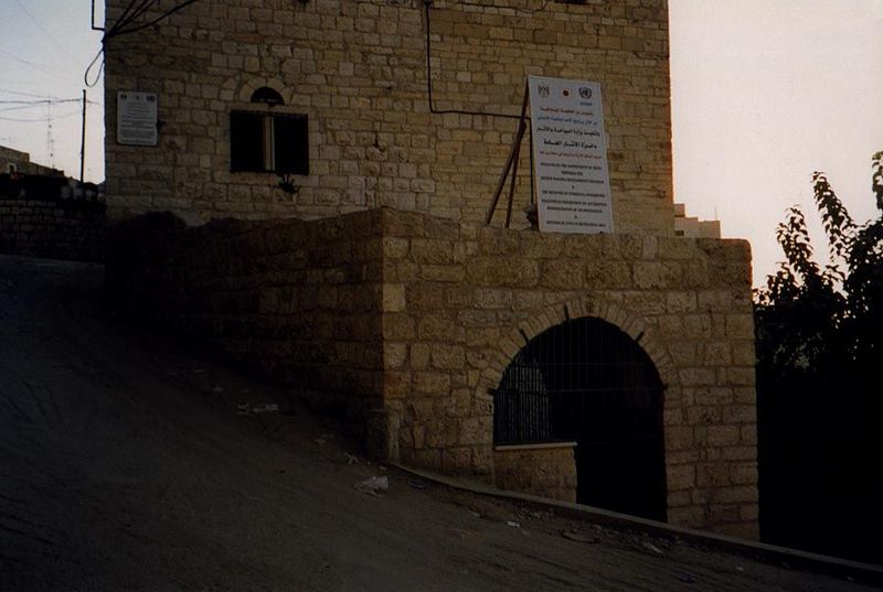 A sign identifies the foreign donors who paid for the restoration work. The Church of the Nativity lies up the hill to the left, and the ori