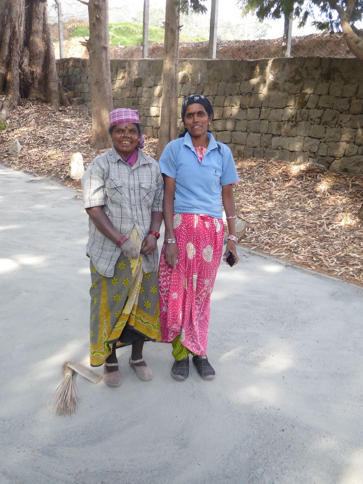 New India: these two women were sweeping grit off the club's driveway while chatting up a storm not with each other but on their cell phones