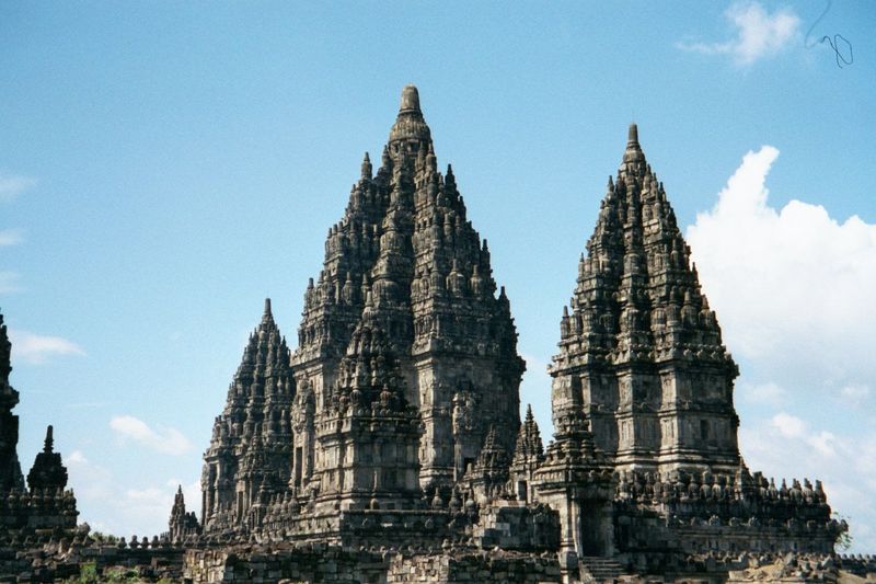 Shiva Mahadeva is flanked by smaller temples to Brahma and Vishnu. Unlike Borobudur, which invites climbers, these temples keep pilgrims at 
