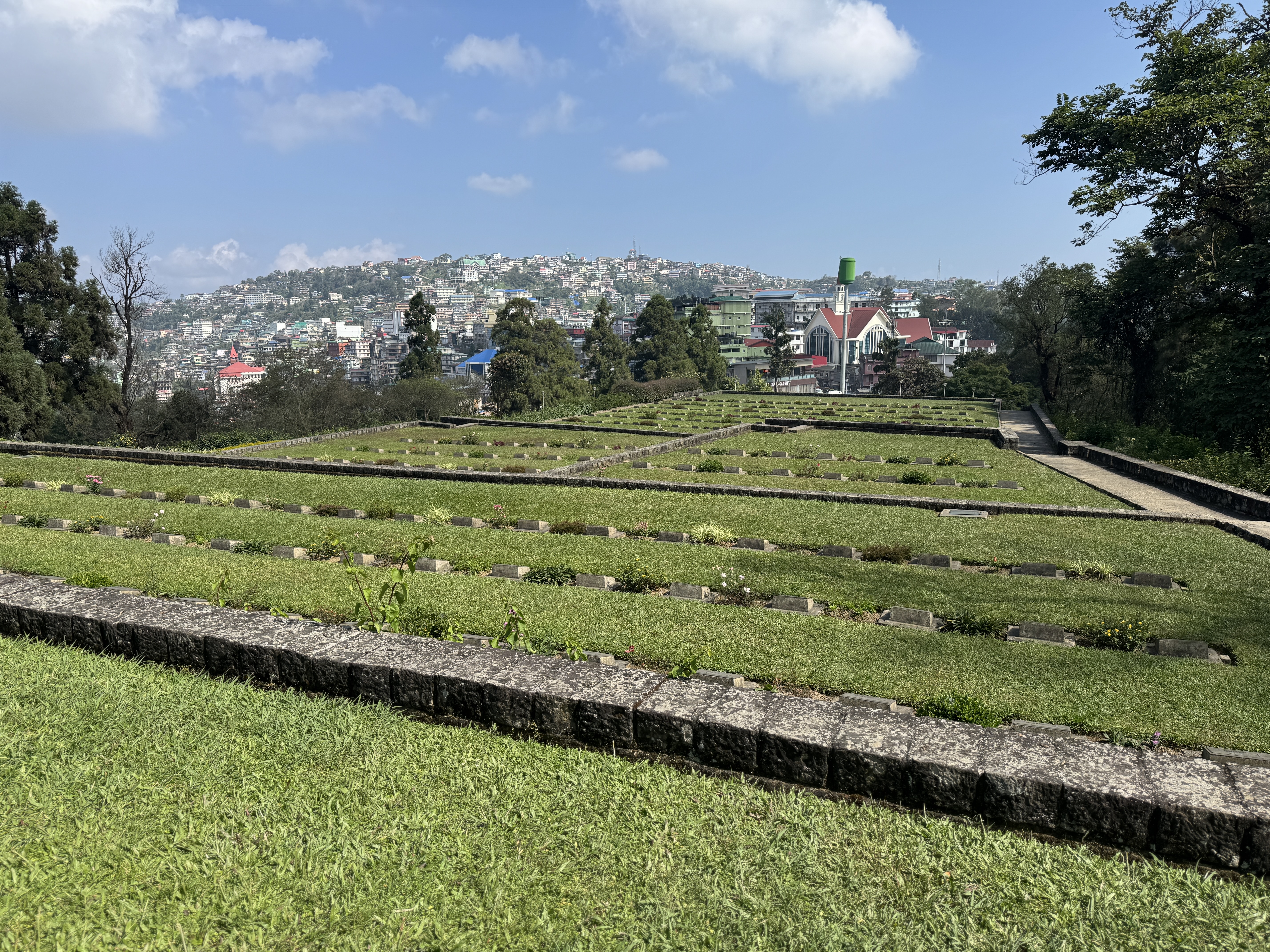 The only tidy bit of Kohima is the Commonwealth War Cemetery, scene of a ferocious battle in 1944.  It contains about 1,400 graves.

Ninety 
