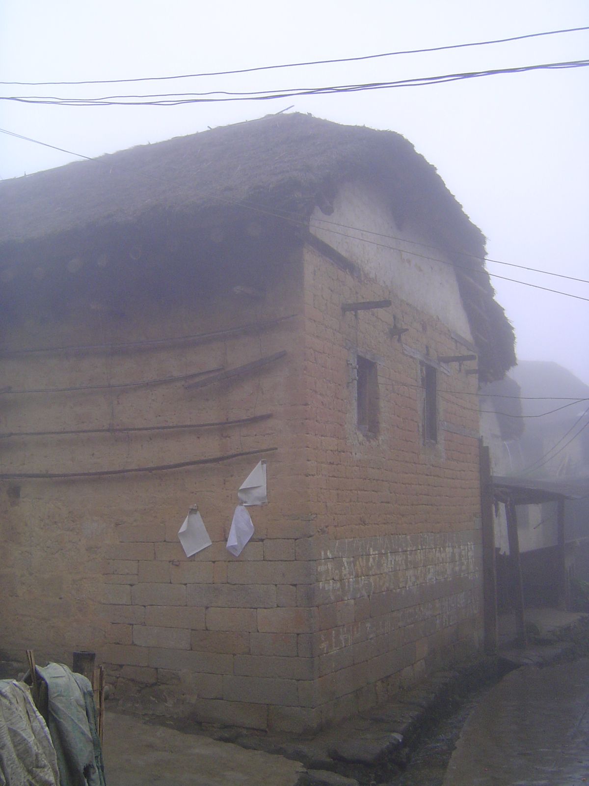 Farther into the village. Notice the long rods? They're for drying noodles.