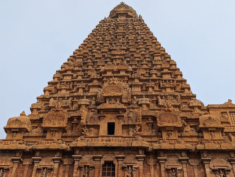 There are a dozen square tiers under a conical cap.  The regularity of the ornamentation reminds me a supermarket display of soft drinks.  T