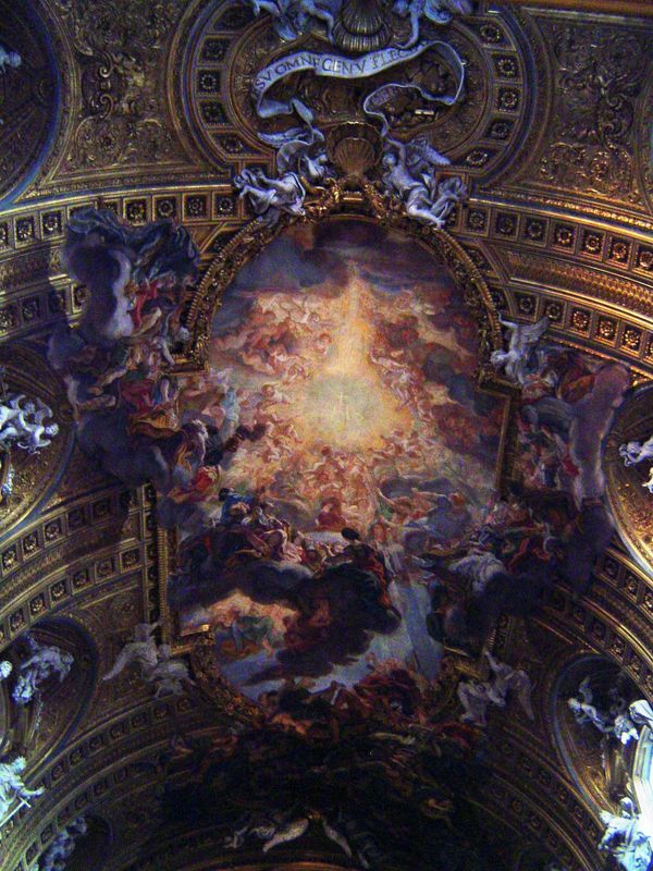 The nave fresco is entitled "The Triumph of the Name of Jesus," and the letters of the Jesuit seal IHS can be faintly discerned in the centr