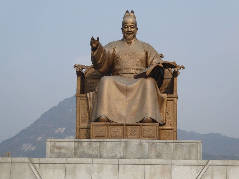 It's King Sejong, who reigned 1418-1450 and is shown in this recent statue with an open book, not because he ruled transparently but because