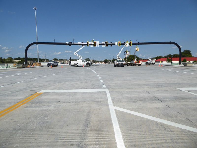 What does a growing town need? Why, what else but new freeway interchanges. Here's a splendid single-point interchange the day before its gr
