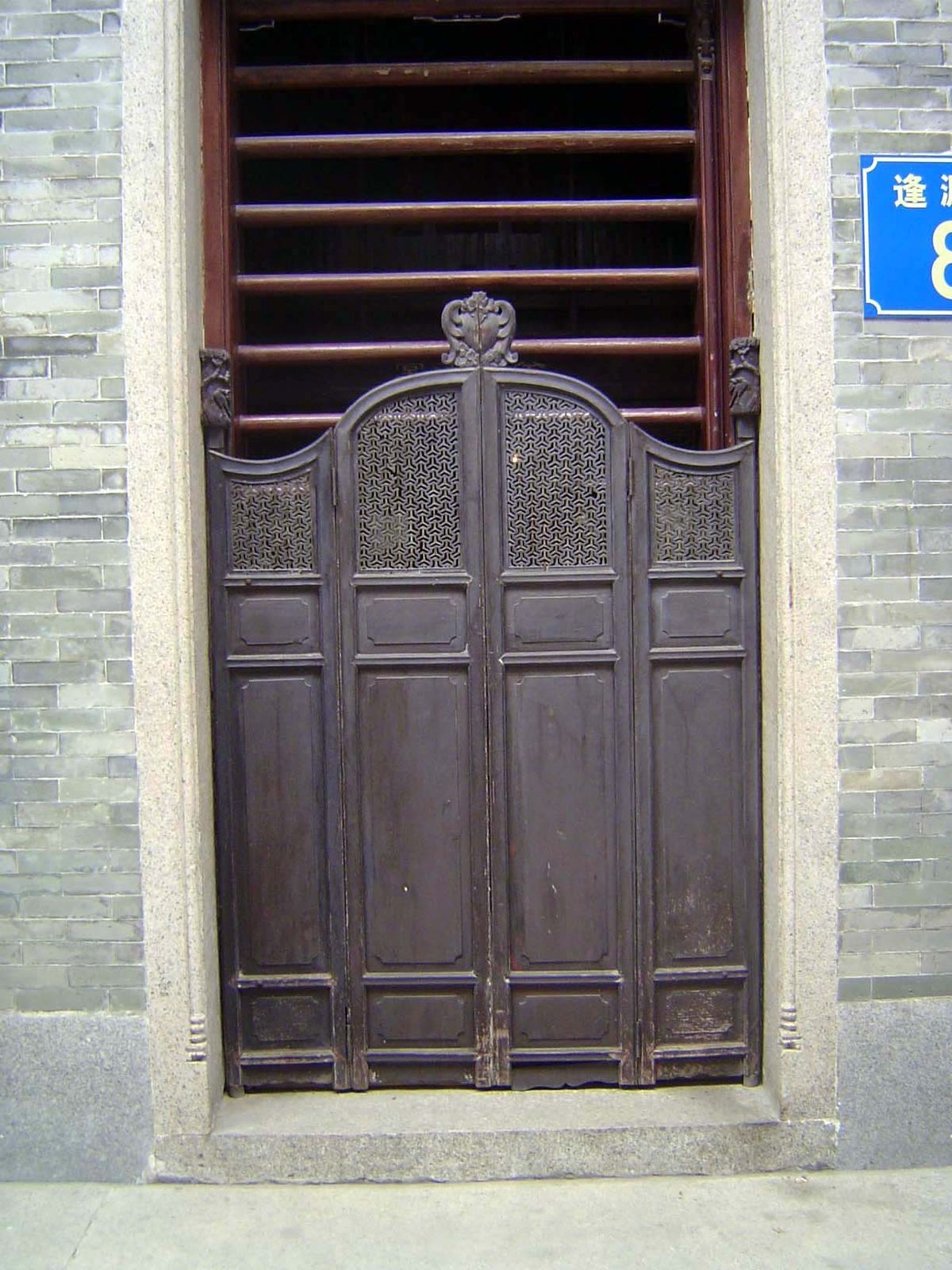 The traditional door: a privacy screen and a security gate of sliding poles.