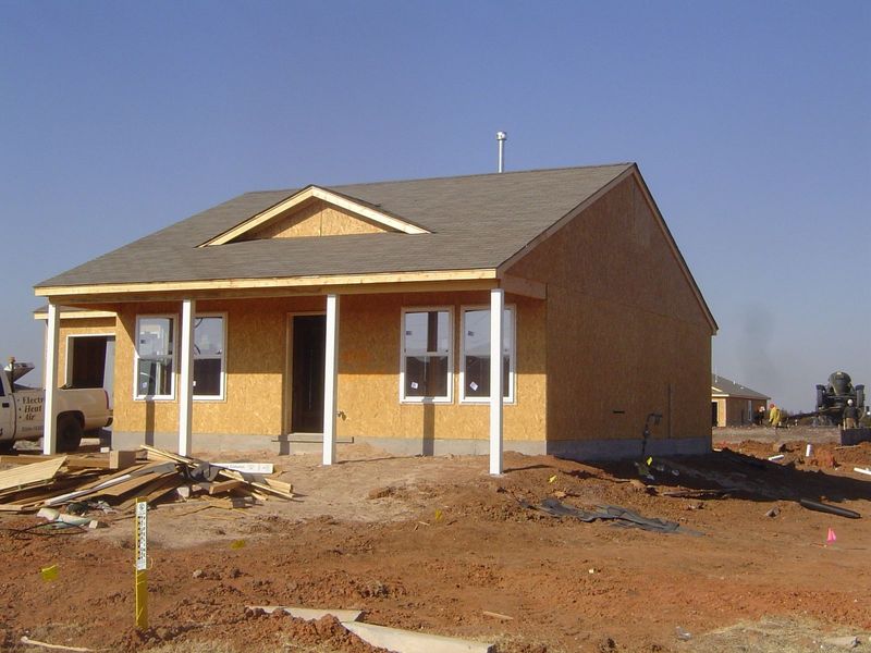 You can see here some of the underlying structure of the house, including the stem wall and the framing, with OSB or "oriented strand board"