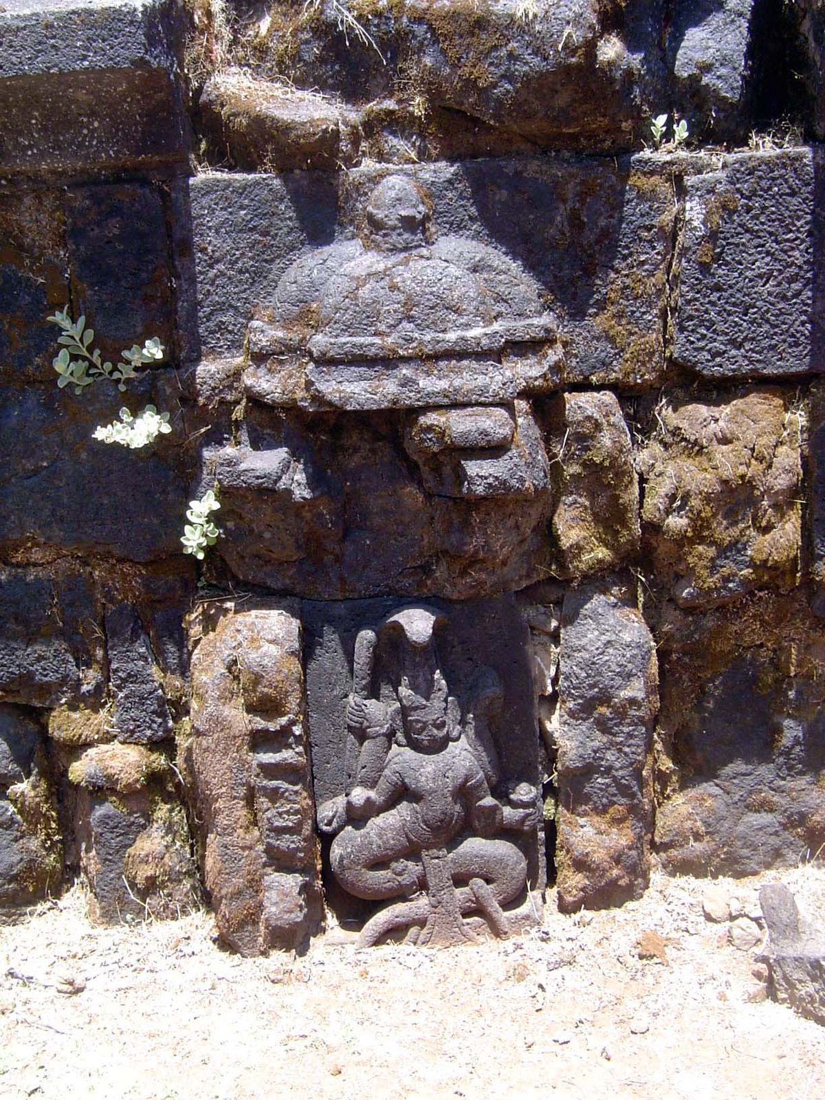 A deity carved on the temple well.
